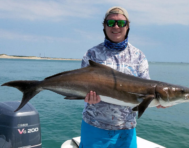 Angler holding giant cobia on Outer Banks of NC.