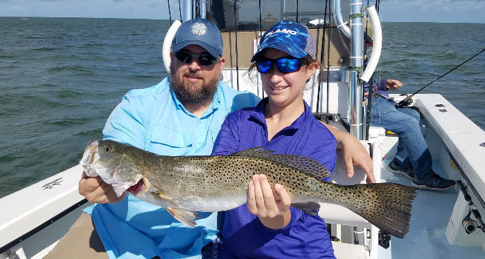 Couple displays a nice Speckled Trout they caught on Pamlico Sound.