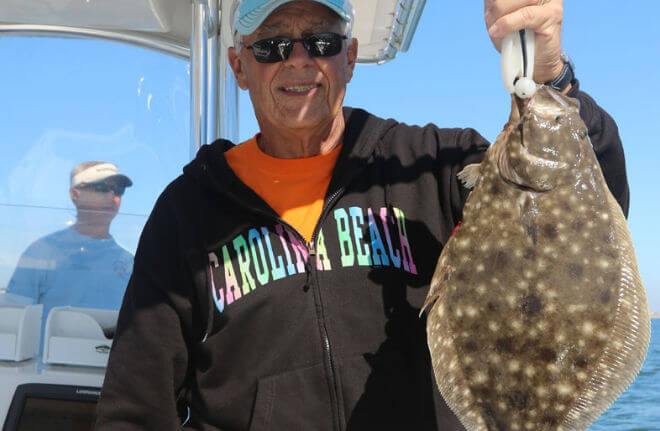 Angler holding nice Flounder.