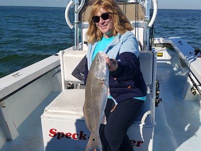 Lana holding a nice Red Drum.