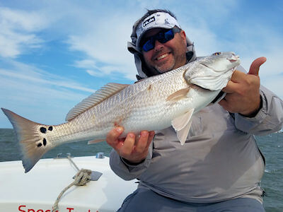Hatteras angler holding fish for Pamlico Sound fishing reports page.
