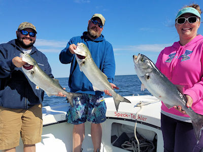 Charter group holding fish for the camera.