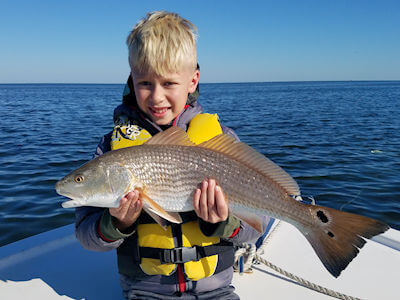 Hatteras angler holding fish for Pamlico Sound fishing reports page.