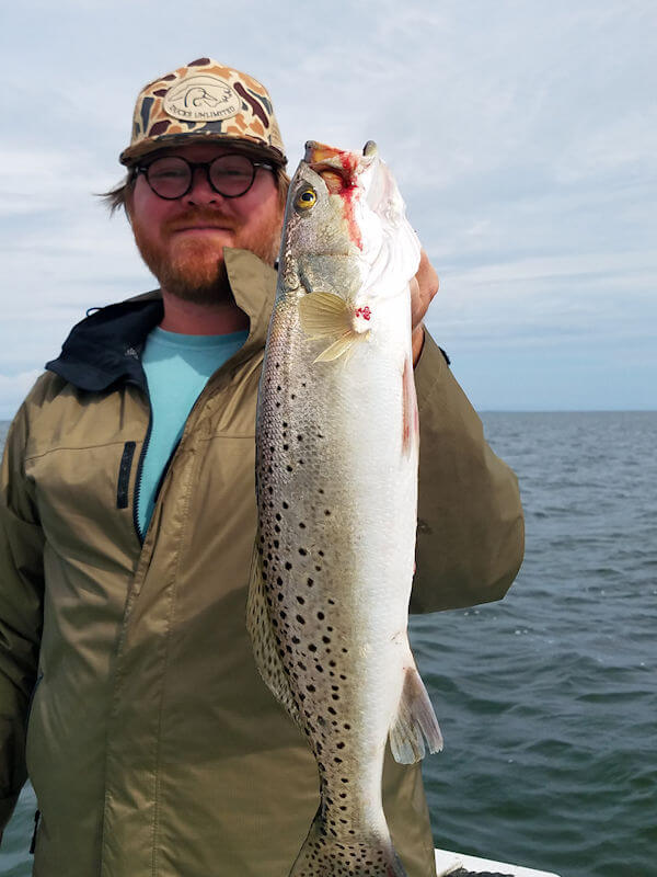 Angler holds up nice Hatteras Island Red Drum.
