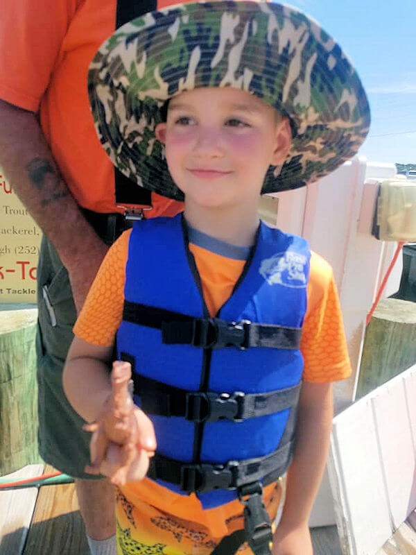 Young man found playing with dino was a bit more interesting than fishing.