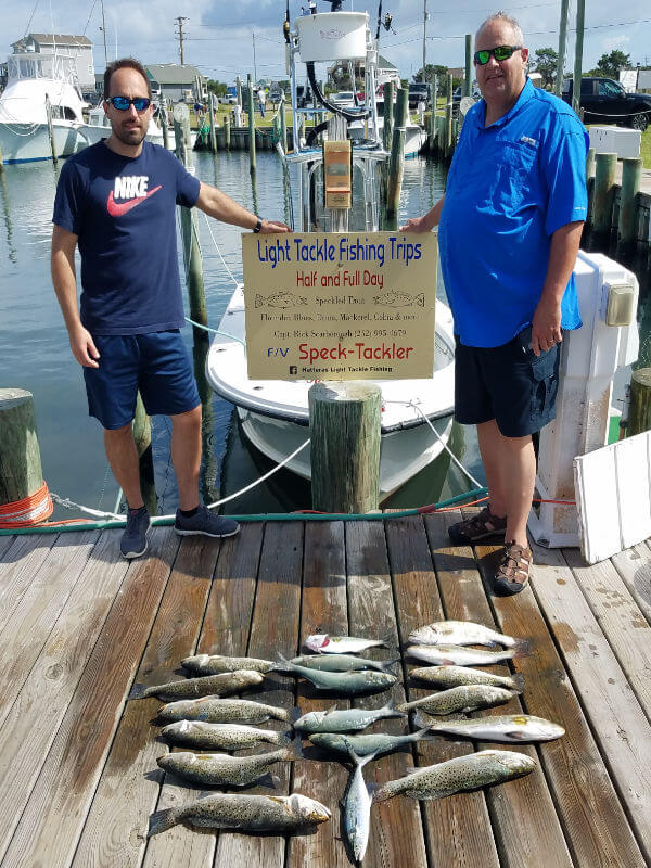 Mike and Dan standing behind their charter catch laid out on the Teach's Lair Dock.