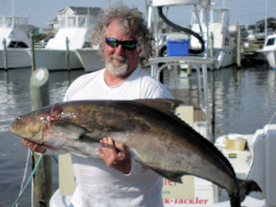 Hatteras angler holding fish for Pamlico Sound fishing reports page.